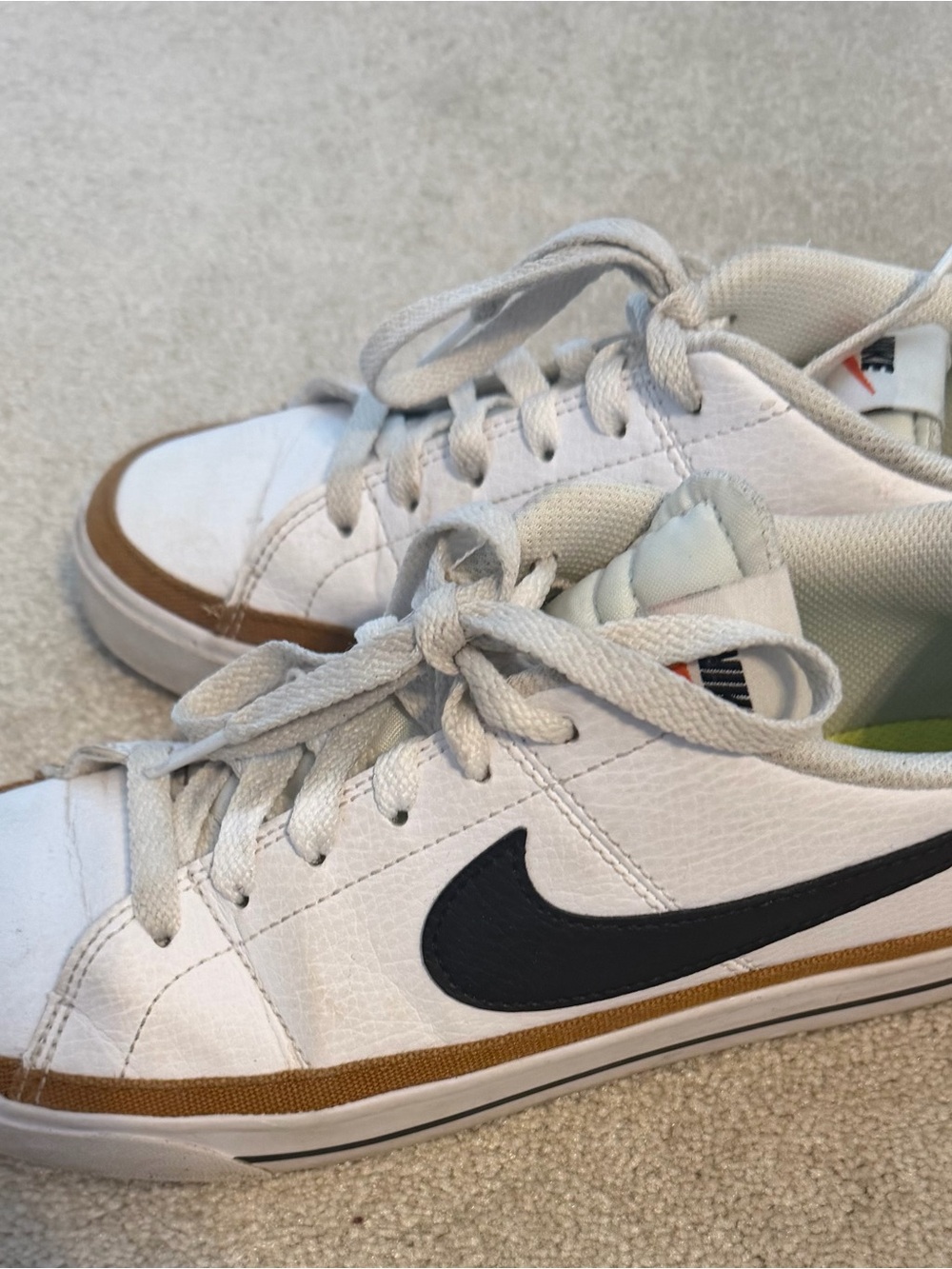 Nike White Low-Top Sneakers with Black Swoosh and Brown Accent